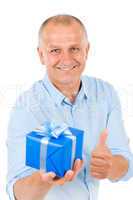 Senior happy man hold present thumb up
