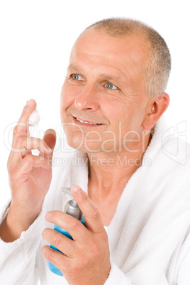 Male cosmetics - senior mature man wash face
