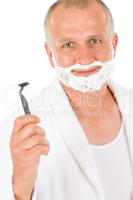 Male cosmetics - Mature man shaving his beard