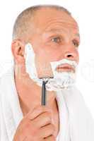 Male cosmetics - Mature man shaving his beard