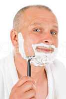 Male cosmetics - Mature man shaving his beard