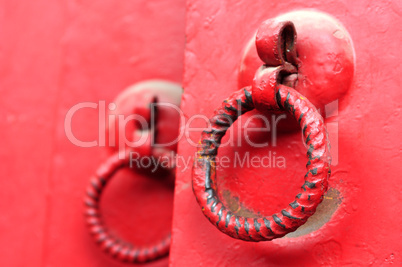 Red door with iron doorknobs