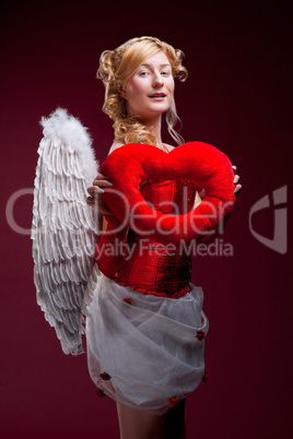 Perfect blonde angel with a red heart