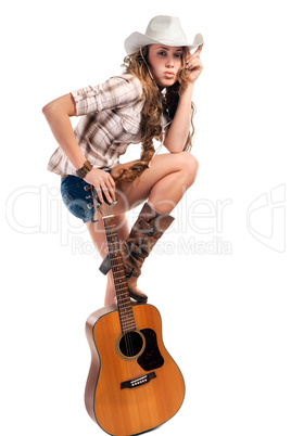 Sesy cowgirl in cowboy hat with acoustic guitar