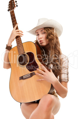 Sesy cowgirl in cowboy hat with acoustic guitar