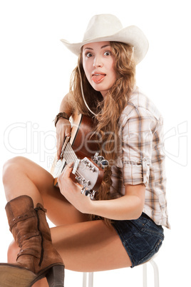 Sesy cowgirl in cowboy hat with acoustic guitar