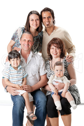 Studio Shot Of Family Group Sitting In Studio