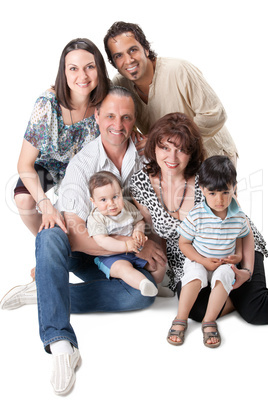 Studio Shot Of Family Group Sitting In Studio