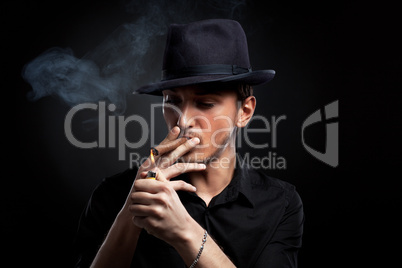 Gangster look. Man with hat and cigar.