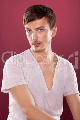 Young handsome man in a white shirt over red