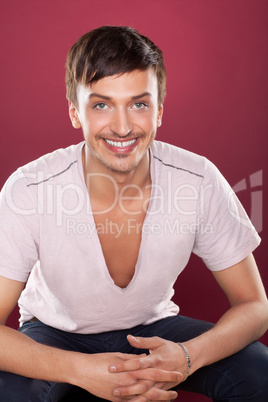Young handsome man in a white shirt over red