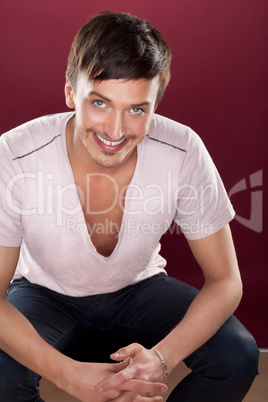 Young handsome man in a white shirt over red