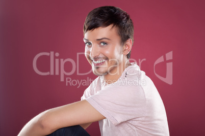 Young handsome man in a white shirt over red