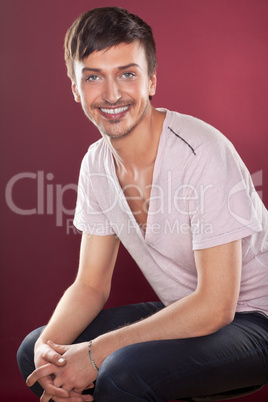 Young handsome man in a white shirt over red