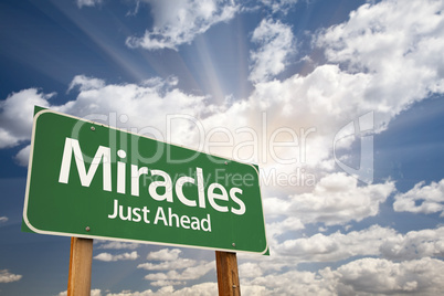 Miracles Green Road Sign Against Clouds