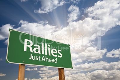 Rallies Green Road Sign Against Clouds