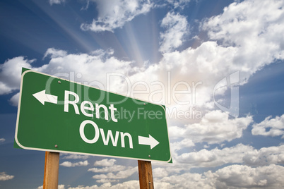 Rent, Own Green Road Sign Against Clouds