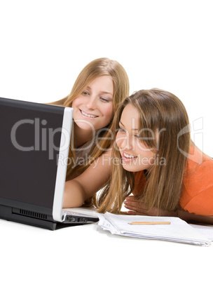 two young happy student girl work on laptop