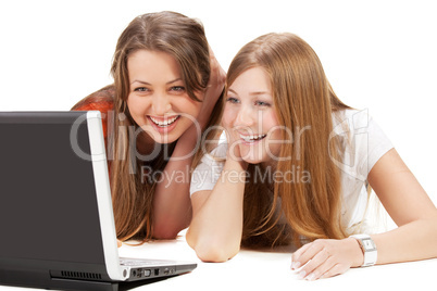 two young happy student girl work on laptop