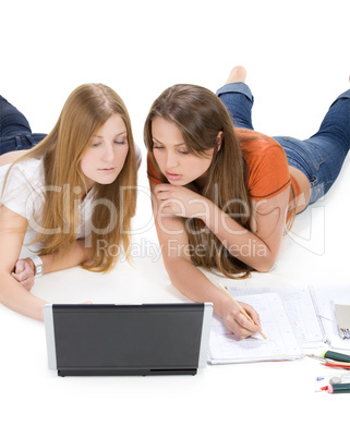 two young happy student girl work on laptop