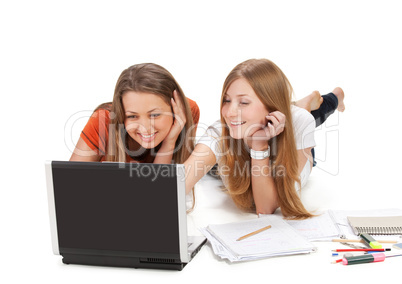 two young happy student girl work on laptop