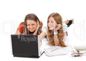 two young happy student girl work on laptop