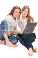 two young happy student girl work on laptop