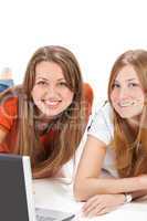 two young happy student girl work on laptop