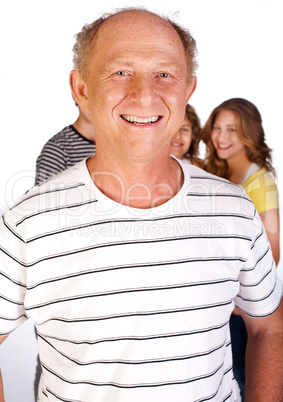 Handsome old man in focus with family in the background