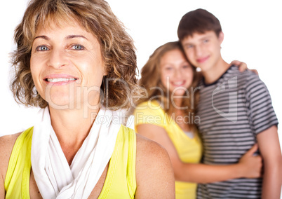 Old lady in focus while mother hugs her son in the background