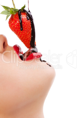 girl eating strawberry with chocolate sauc