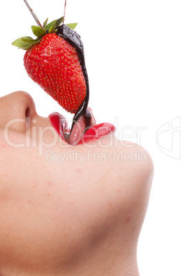 girl eating strawberry with chocolate sauc