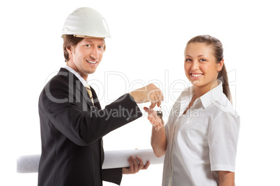 smiling engineer giving keys from apartment