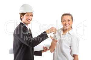 smiling engineer giving keys from apartment