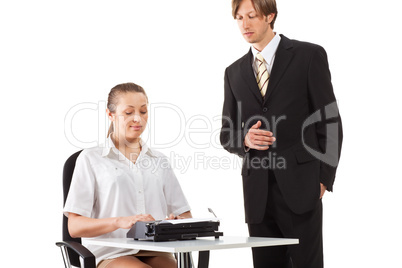 Two businesspeople working with typewriter