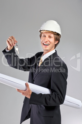 smiling engineer giving keys from apartment