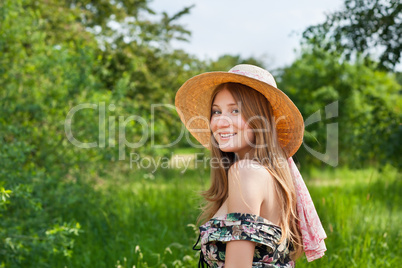 Young beautiful girl with hat posing outdoor