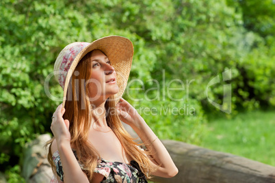 Young beautiful girl with hat posing outdoor