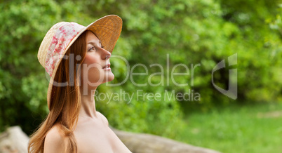 Young beautiful girl with hat posing outdoor