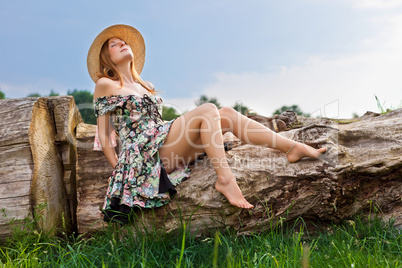 Young beautiful girl with hat posing outdoor