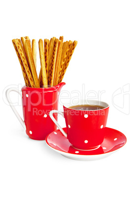 Bread sticks and coffee in the red utensil