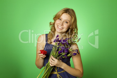 Attractive girl holding flowers and a gift box