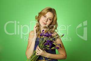 Attractive girl hugging a bouquet of Irises