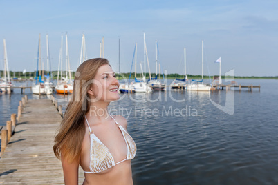 Attractive young woman near the yachts