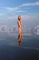 girl posing in the Water at sunset,