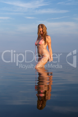 girl posing in the Water at sunset,