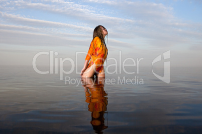 girl posing in the Water at sunset