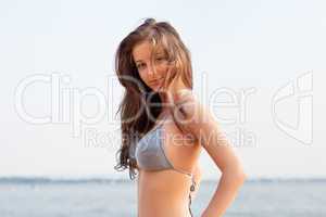 beautiful young woman on water background
