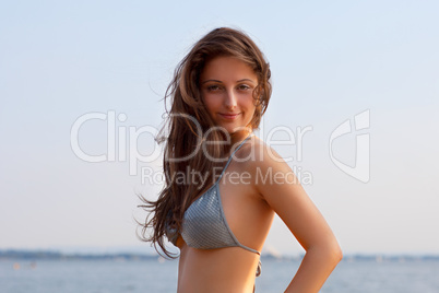 beautiful young woman on water background