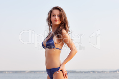 beautiful young woman on water background